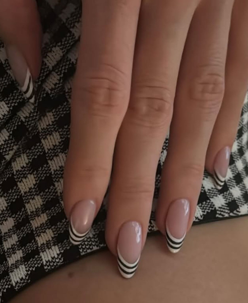 nail trends 2026 funky french manicure with black and white stripes